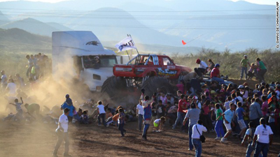 People run as an out of control monster truck plows through a crowd of spectators at a Mexican air show in the city of Chihuahua, Mexico, Saturday Oct. 5, 2013. According to authorities, at least 8 people were killed and 80 were injured. Photo courtesy: CNN.