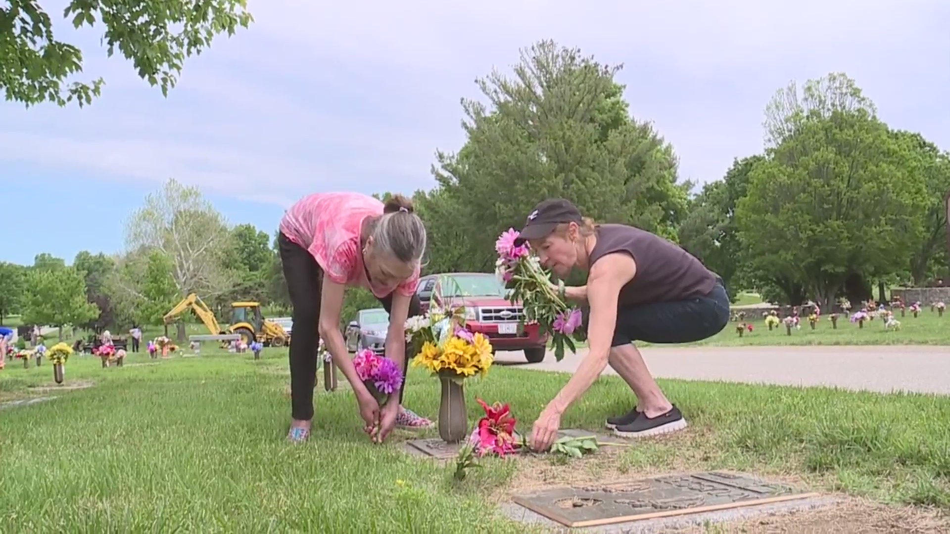 Picture of women laying flowers on grave site
