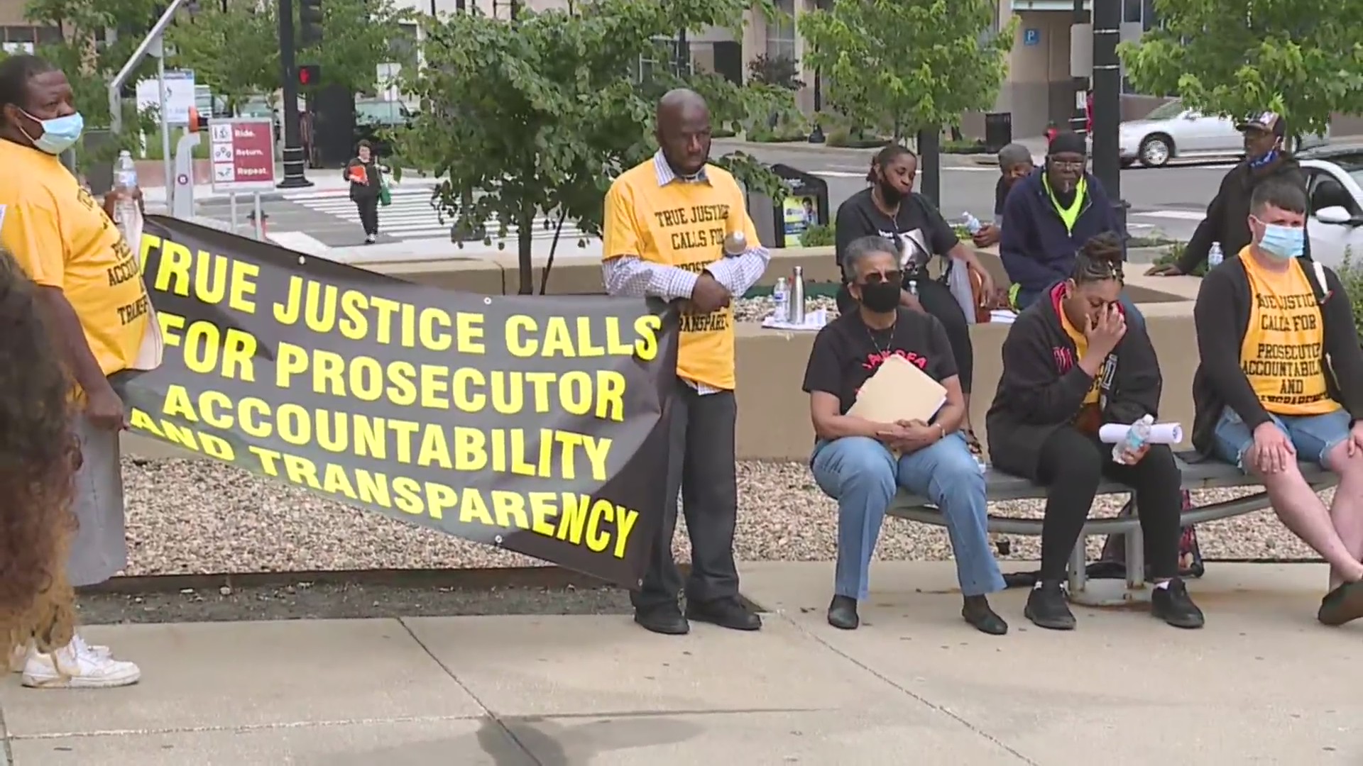 Picture of protesters holding a sign