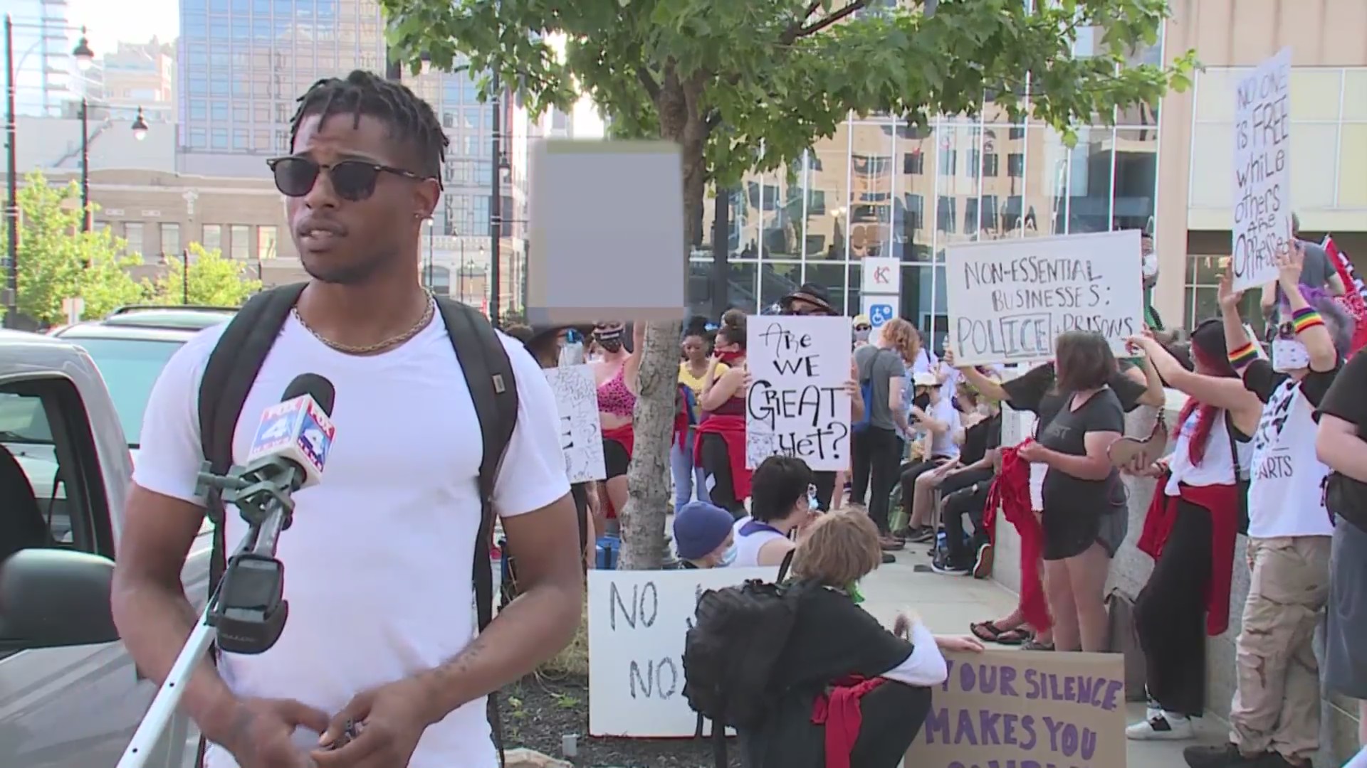 Picture of protests with organizer in the foreground