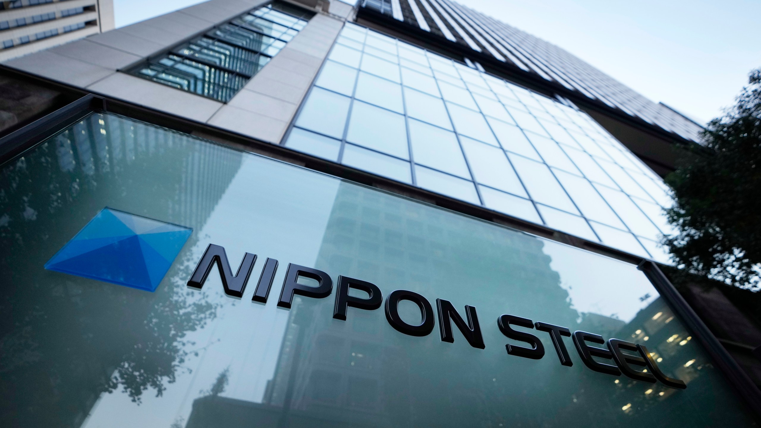 FILE - Nippon Steel Corporation's logo is displayed on a sign outside its headquarters in Tokyo on Nov. 26, 2021. Nippon Steel Corp. has dropped its lawsuit against Toyota Motor Corp. over a patent for a technology used in electric motors, saying wrangling among Japanese companies was not beneficial to keep the nation competitive, according to Japan’s top steelmaker's statement Thursday, Nov. 2, 2023. (AP Photo/Hiro Komae, File)
